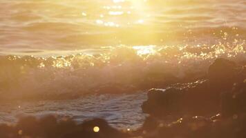 Golden seawater close up detail, slow motion video