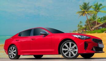 Red car on a background of palm trees. Modern, bright image of the car for design solutions. photo