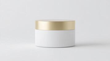 Round cosmetic container with a gold lid, featuring a smooth white body, placed on a minimalistic background, showcasing modern design and elegance for beauty products and packaging photo