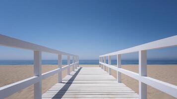 Wooden boardwalk extends towards the calm ocean, framed by white railings, leading to a serene beach under a clear blue sky, inviting relaxation and tranquility photo