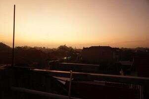 Sunset over the rooftops of a city photo