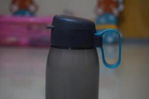 A black and blue water bottle with a handle photo