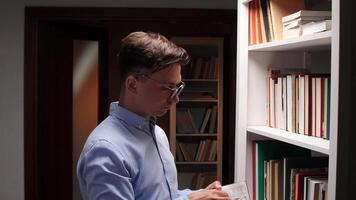 University professor concealing banknotes behind books on a library bookshelf, illustrating themes of corruption and illegal payments within the academic environment video
