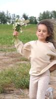 A young girl running in the field with flowers video
