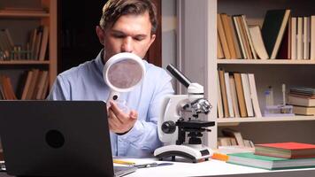 A man looking through a magnifying glass at a laptop video