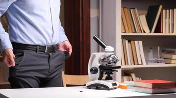 A man in a shirt and tie standing next to a microscope video