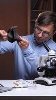 A man in glasses is looking at a piece of paper video