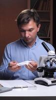A man is looking at a microscope video
