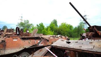 Exhibition o destroyed military equipment of the russian army. Rusty and burned-out armored vehicles on ukrainian territory. War between Ukraine and russia. Close up Slow motion video