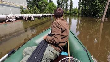 Volunteer sail on boat to evacuate animal and people after detonation of Hydroelectric Power Station. Flooding in Kherson as result of explosion of dam on Dnipro river in city of Novaya Kakhovka video