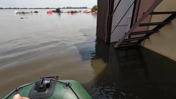 Male hands of volunteer rowing with an oar the boat after detonation of Hydroelectric Power Station. Flooding in Kherson as result of explosion of dam on Dnipro river in city of Novaya Kakhovka video