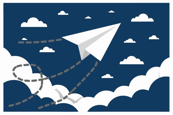 White paper airplane soaring through a cloudy sky on a dark blue background representing travel and dreams