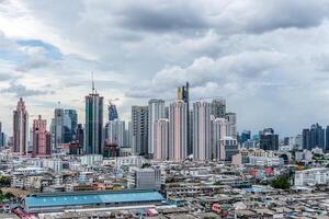 A city skyline with tall buildings and lots of people photo