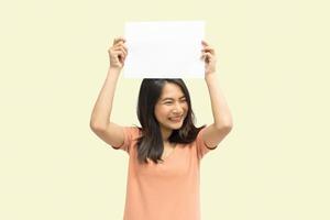 Woman showing blank white paper for copy space photo
