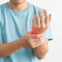 Person experiencing pain and inflammation in their wrist photo