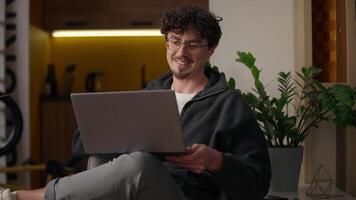 Smiling Caucasian guy hipster speaking online meeting laptop at home glad man freelancer distant conference male waving hand entrepreneur talk computer businessman conversation call negotiation video