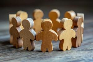 Wooden figures holding hands in a circle on a rustic table photo