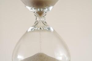 A minimalist conceptual image of an hourglass to symbolize the passage of time, aging, and importance of skincare, balance. photo