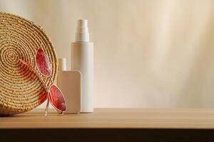 Elegant arrangement of a bag, sunglasses, and cosmetic spf bottles on a simple beige backdrop. Lowkey natural concept of summer luxury skincare and protection, warm tone minimalist muted photo