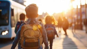 Elementary school children walking side by side, smiling and heading toward yellow school bus under bright afternoon sunlight photo