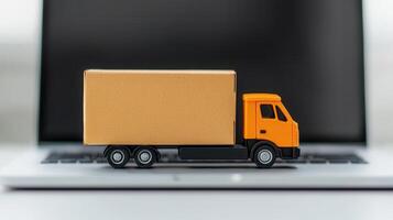 Miniature delivery truck shipping cardboard package beside laptop, representing e commerce convenience and rapid carrying logistics photo