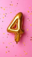 Golden numeric balloon on marking birthday celebration, scattered colorful confetti four pastel pink backdrop photo