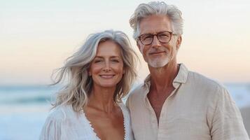 Senior couple embracing, smiling during golden hour embodying sharing tender moment on sandy beach, sunset, lasting romantic love photo