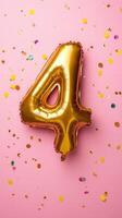 Golden numeric balloon four marking celebration, backdrop scattered colorful confetti on pastel pink birthday photo