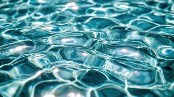 Sunlight creates beautiful reflections on the rippling surface of a swimming pool, ideal for summer and vacation themes photo