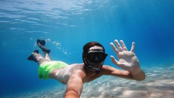 man with mask and fins waves underwater video