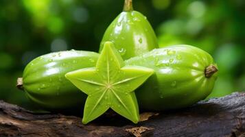 Star fruit slices and whole fruit on a dark surface. photo