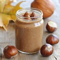Delicious Hazelnut Spread in a Glass Jar with Autumnal Setting. photo