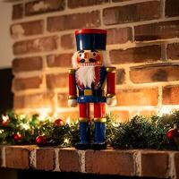 Festive Nutcracker Figurine on Brick Mantelpiece with Christmas Garland and Lights. photo