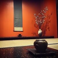 Serene Tea Ceremony Setting Tranquil Asian-inspired Interior with Blossoms and Teapot. photo