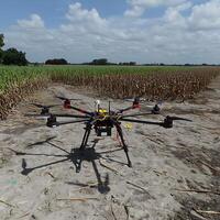 Agricultural Drone in Cornfield Precision Farming Technology. A hexacopter drone stands ready for agricultural survey in a field of harvested corn. photo