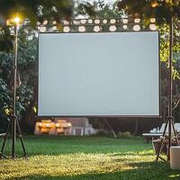 Outdoor Movie Screen Setup in a Garden at Sunset. A blank projection screen is ready for a film screening in a backyard setting. photo