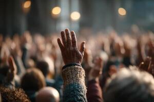 A crowd of people raising their hands in the air photo