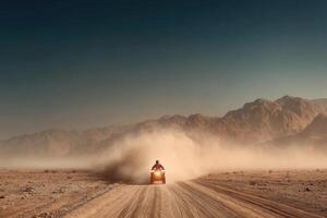 A man riding a motorcycle on a dirt road photo
