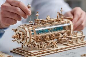 A man is working on a model of a steam engine photo