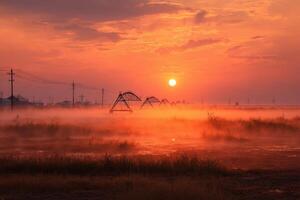 A foggy field with oil pumps and power lines photo
