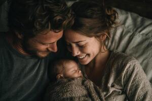 A man and woman are smiling while holding their baby photo