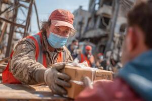 A man wearing a mask and gloves is handing a box to another man photo