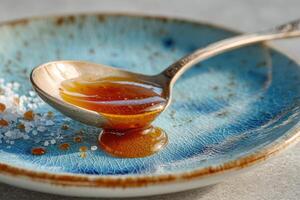 A spoon with honey and sugar on it photo
