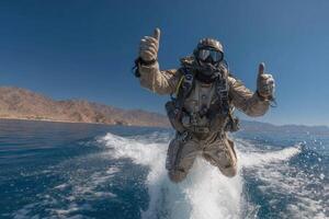 A man in a diving suit is on a boat in the ocean photo