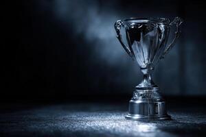 Silver trophy on dark background photo