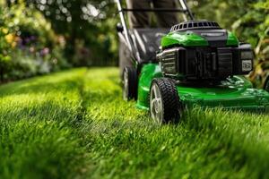 A green lawn mower is being used in the yard photo