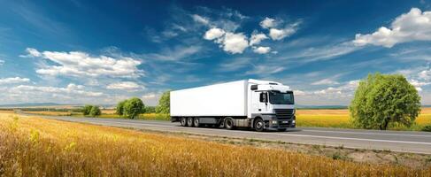 The large white truck driving through a picturesque countryside landscape photo