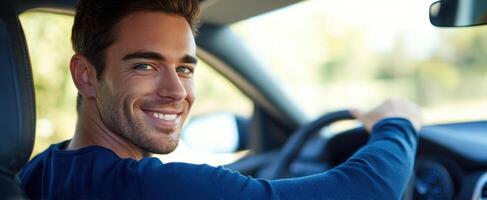 The man driving and smiling brightly in a modern car interior. photo