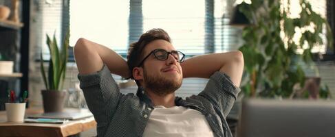 The man enjoying a moment of relaxation in a modern office space. photo