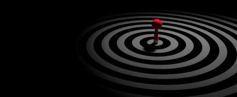 The red object in the mesmerizing black circular pattern. photo